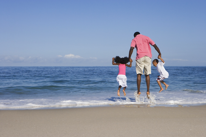 family jumping in water family jumping in water